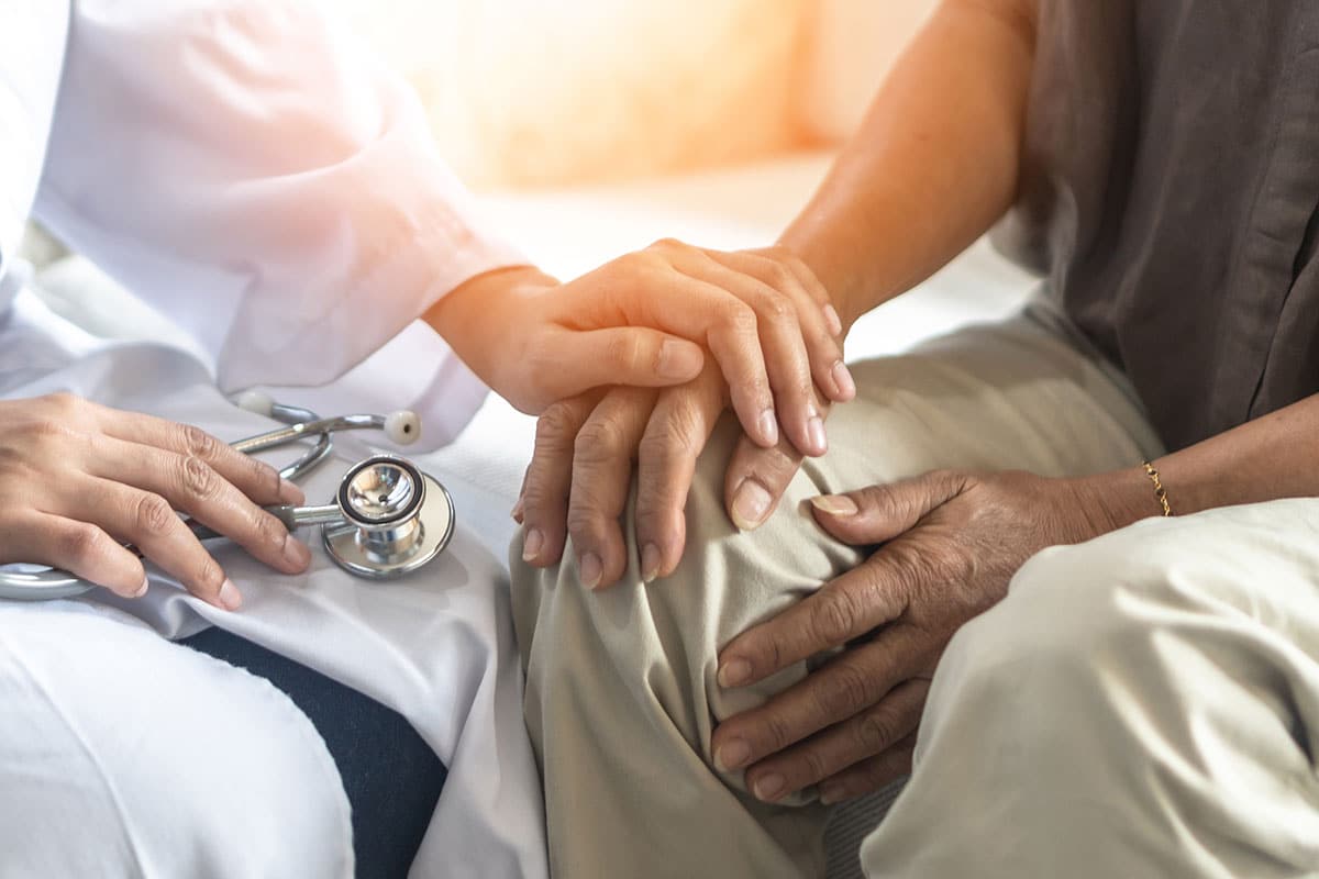 doctor comforting Parkinson’s patient during deep brain stimulation follow-up care in first year after surgery