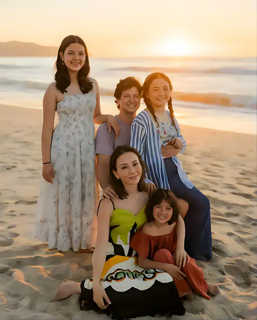 The Taghva family poses on a beach at sunset, supporting Johns Hopkins students through an experiential learning fund.